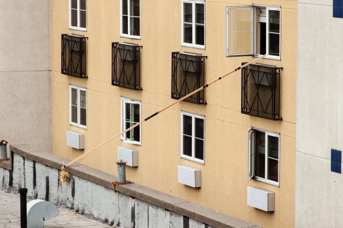 Jerry-rigged pole extends out hotel room window.